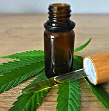 cbd oil with cannabis leaf.