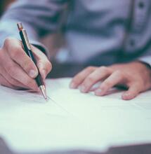a lawmaker signing a bill. 