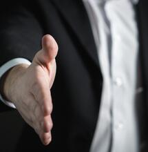 business man offering a handshake. 