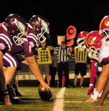 American football players on the field ready to start the game.