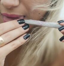 woman licking a joint. 