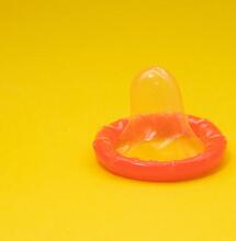 condom against a yellow background. 