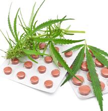 cannabis leaf with tablets. 