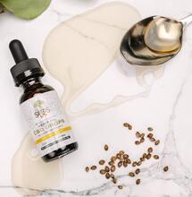 bottle of cannabis oil along with some seeds. 