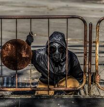 man at Chernobyl site wearing gas mask