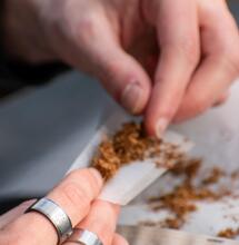 person rolling tobacco. 