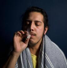 a young man smoking.