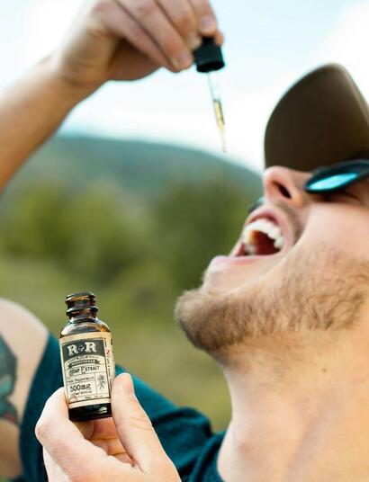 a man administrating cbd oil. 