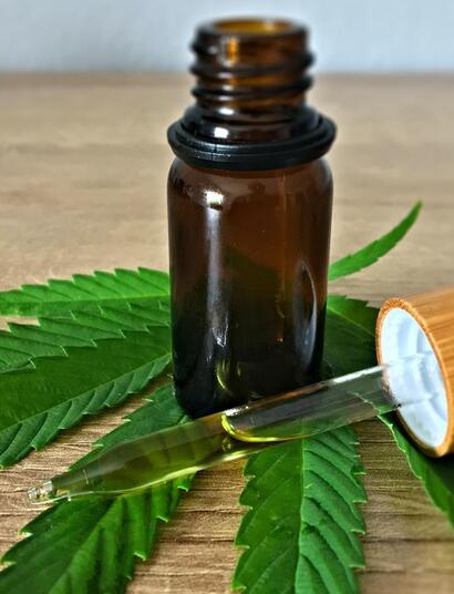 cbd oil with cannabis leaf.