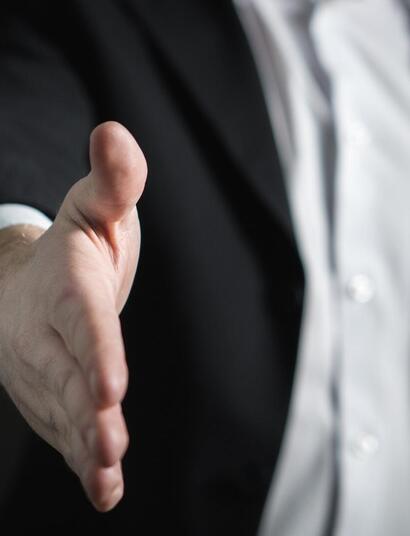 business man offering a handshake. 