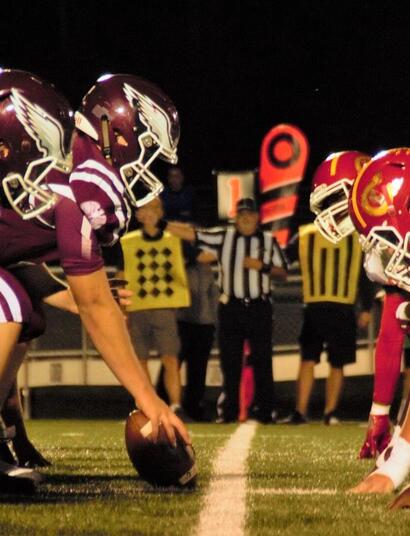 American football players on the field ready to start the game.
