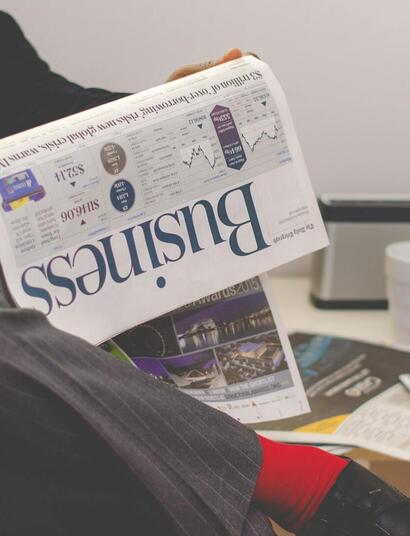 man in suit reading finance news.