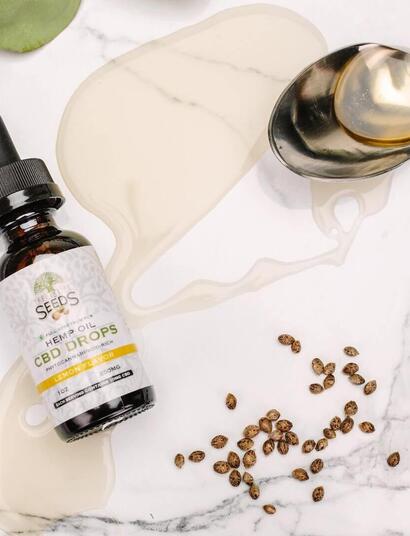 bottle of cannabis oil along with some seeds. 