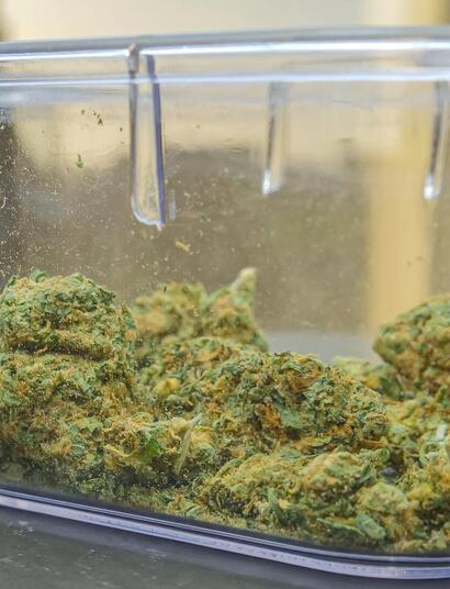 A sealed container with green kush. 