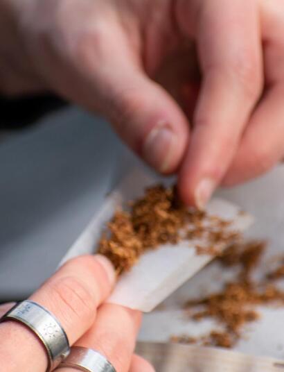 person rolling tobacco. 