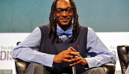 Snoop Dogg wearing business attire.