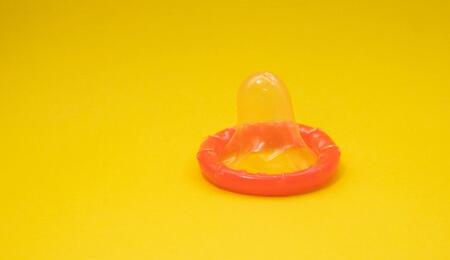 condom against a yellow background. 