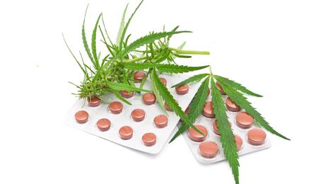 cannabis leaf with tablets. 