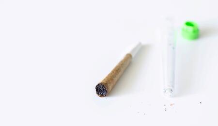 rolled joint against a white background. 