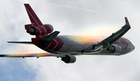 a plane taken off and flying in the sky and the clouds