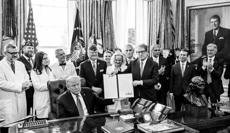 President Donald Trump signs an executive order reclassifying marijuana as a Schedule III substance with looser restrictions in the Oval Office, Thursday, December 18, 2025. (Official White House Photo by Molly Riley)