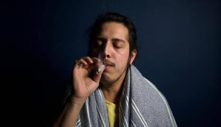 a young man smoking.