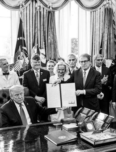 President Donald Trump signs an executive order reclassifying marijuana as a Schedule III substance with looser restrictions in the Oval Office, Thursday, December 18, 2025. (Official White House Photo by Molly Riley)