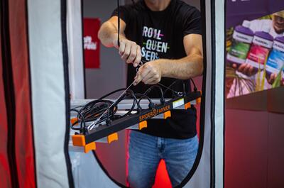 Drew Anger installing hanging bars in a growing tent for weed.